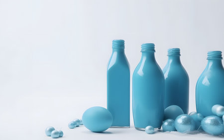 Cosmetic bottles on white background with blue christmas balls and pearlsの素材