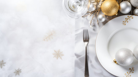 Christmas table setting with silver and white christmas decorations on white backgroundの素材