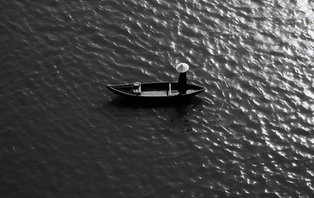 Black and white image of a boat on the river. View from above.の素材