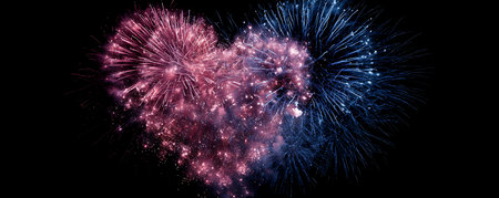 Colorful fireworks in the shape of a heart on a black backgroundの素材