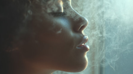 Close up portrait of a beautiful african american young woman with smoke.の素材