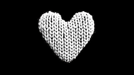 White knitted heart on a black background. Valentine's Day.の素材