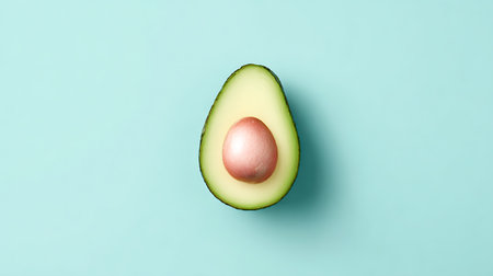 Avocado with egg on turquoise background. Minimal food concept.の素材
