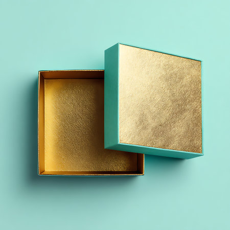 top view of open gift box on turquoise background with copy spaceの素材