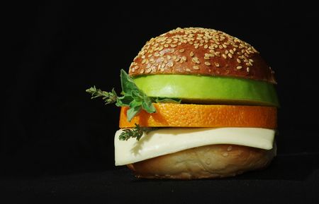 Vegetarian sandwich with orange and apple on black backgroundの写真素材