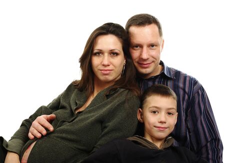 Father, son and pregnant mother hugging, isolated on whiteの写真素材