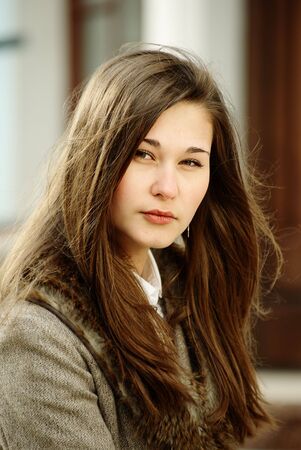 Beautiful brown hair girl outdoors portraitの写真素材