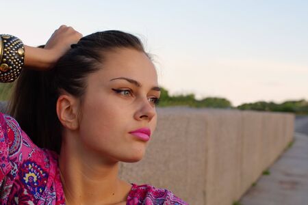 Portrait of the girl enjoying evening sun outdoors