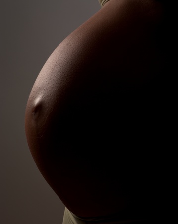Belly of pregnant woman with navel inside outの写真素材