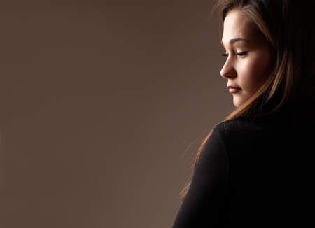 Backlit portrait of an asian woman profile in low keyの写真素材