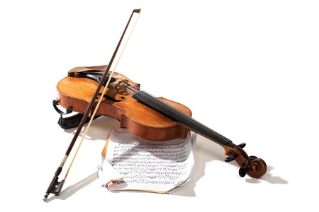 Old violin bow and notes crossed isolated on whiteの写真素材