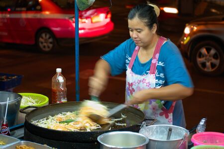 BANGKOK - MARCH 03: Street cook woman preparing phat thai noodles in the night, March 02, 2011, Bangkok, Thailandのeditorial素材