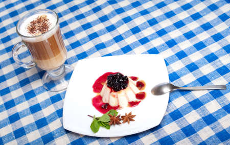 Panna cotta and coffee on the checkered tableclothの写真素材