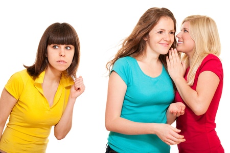 Woman eavesdrops gossip of two women isolated on whiteの写真素材