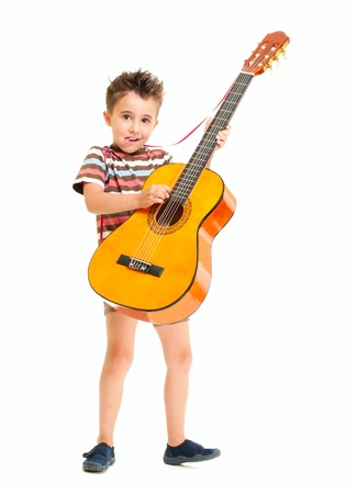 Little boy plays acoustic guitar isolated on whiteの写真素材