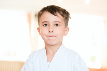 Portrait of karate boy training in sport hall in doubtの写真素材