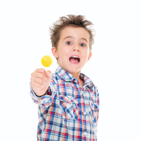 Little screaming excited boy with lollipop in hand isolated on whiteの写真素材