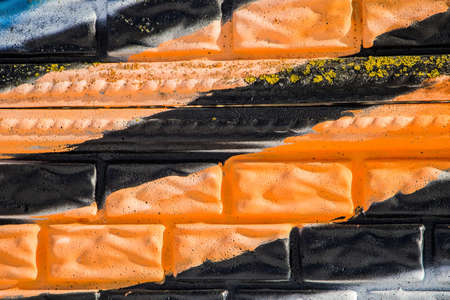Orange and black stripes on a brick wall, St. George ribbon concept