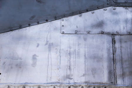Aircraft skin close up. Rivets on gray metal. Aluminum textureの写真素材