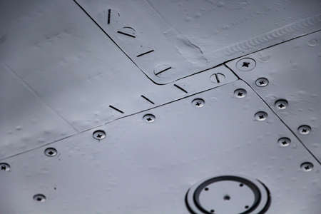 Aircraft skin close up. Rivets on gray metal. Aluminum texture