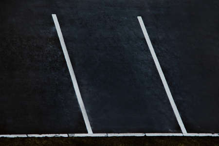 Empty parking during quarantine in the city. White markings for cars on black asphalt.の写真素材