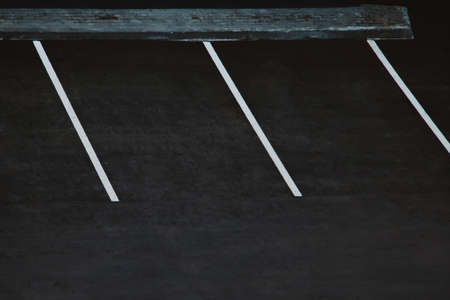 Empty parking during quarantine in the city. White markings for cars on black asphalt.の写真素材