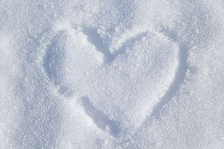 Heart painted on snow, a symbol of love and valentine's dayの写真素材