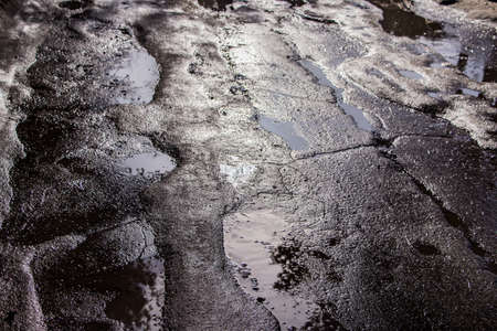 Melted snow on an asphalt road in Russiaの写真素材