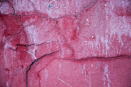 Cracks on a pink wall closeupの写真素材