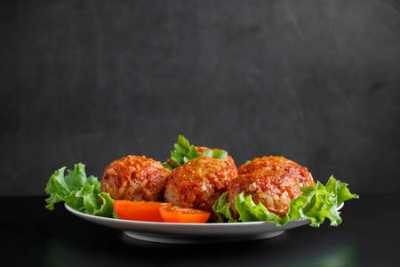 Meat balls in tomato sauce on a black background. Homemade protein meal for healthy eating.の写真素材