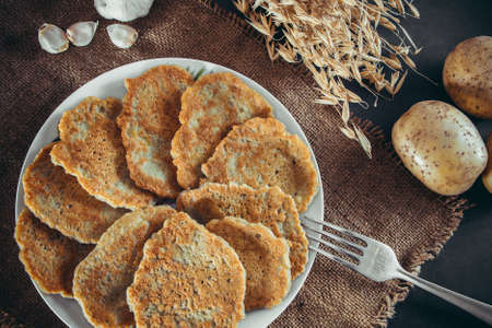 Appetizing toasted potato pancakes on a dark backgroundの写真素材