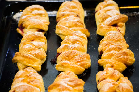 Croissants made of puff pastry stuffed with dark gooseberries