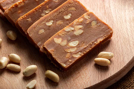 Peanut sorbet on a wooden background. Vegetarian oriental sweet with nuts.