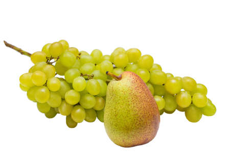Bunch of ripe green grapes and a juicy pear isolated on white background. Branch of ripe green grapes and juicy red pear close-up isolated on a white backgroundの写真素材