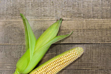 Fresh yellow corn on a wooden background