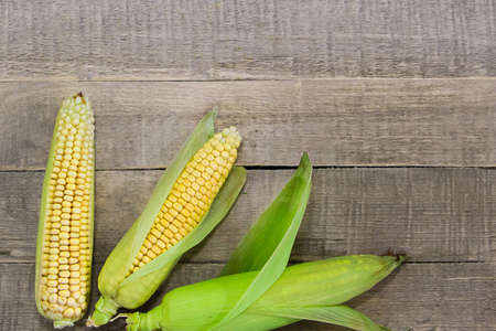 Fresh yellow corn on a wooden background