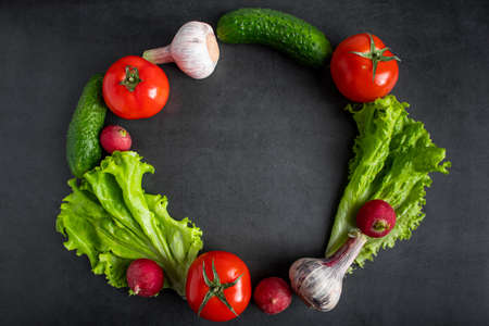 Fresh vegetables on a dark background. The concept of healthy nutrition and diet. Place for text.