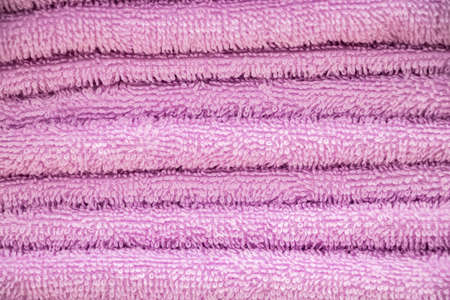 Pink terry towel close-up. A stack of soft bath accessories.の写真素材