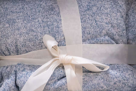 Soft gray plaid with a ribbon. Cozy home accessories.の写真素材