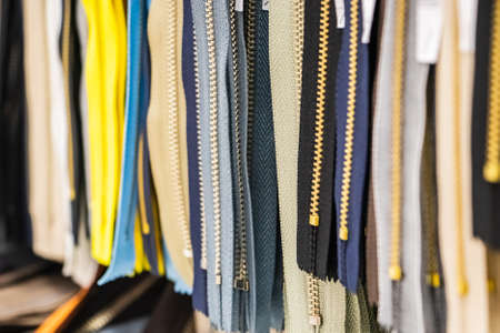 Set of multi-colored sewing zippers. Hobby goods in the store. Background for design. Selective focusの写真素材