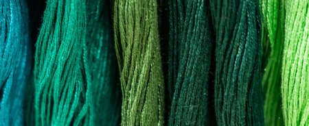 Set of multi-colored threads for embroidery. Background for design, banner format.