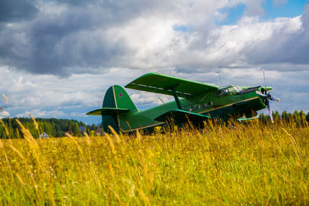 Vintage aircraft preparing for take-off on the background of a stormy sky