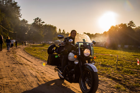 Motorcyclist rides on the road on a sunny summer day. 08.24.2019 - Lida, Belarus.