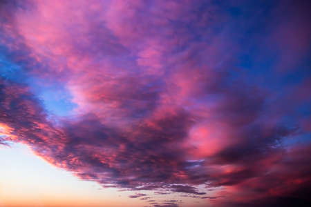 Beautiful pink sunset on the sky. Purple clouds in the sun. Blurred background for design. Selective...