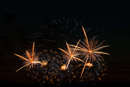 Beautiful festive fireworks in the night sky. Bright multi-colored salute on a black background. Place for text.の写真素材