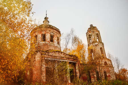Old abandoned stone house in the autumn forest. The ruins of an ancient building