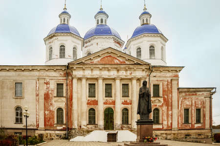 Ancient christian church and autumn yellow trees. Beautiful domes, high bell tower against the sky