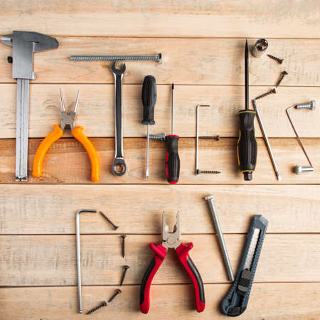 Set of work tools on a wooden background. Festive greeting card concept for Father's day