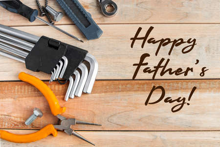 International Father's Day. Greeting card concept. Set of construction tools on a wooden background....