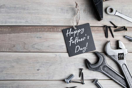 International Father's Day. Greeting card. Work tools on a gray wooden background.の写真素材